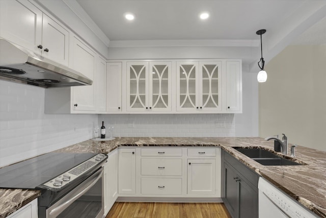 700 W 7th Ave Unit # 601, Spokane, WA 99204 - kitchen with electric stove, under cabinet range hood, white dishwasher, dark stone counters, and white cabinetry