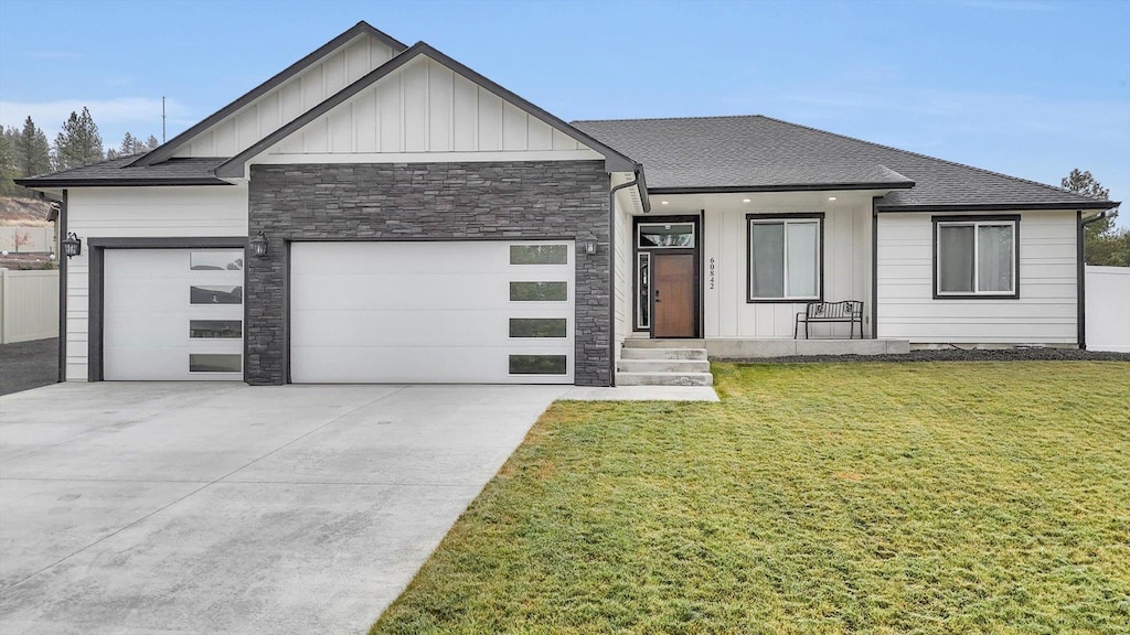 view of front of house with a garage and a front lawn