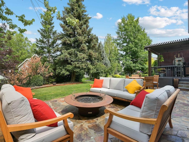 view of patio with an outdoor living space with a fire pit