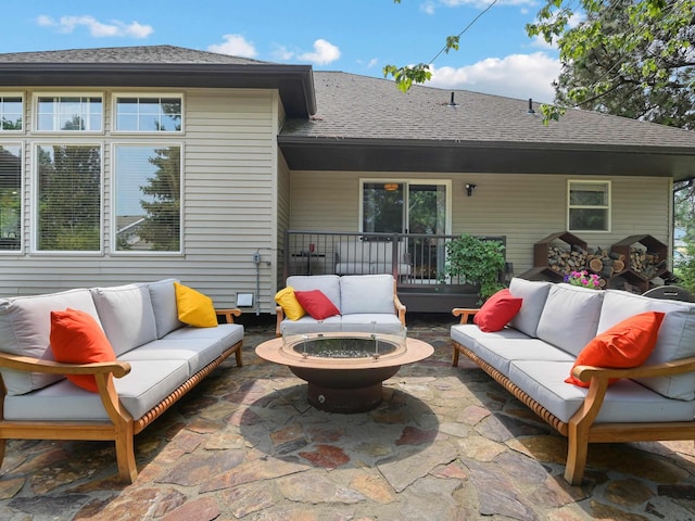 view of patio featuring an outdoor living space with a fire pit