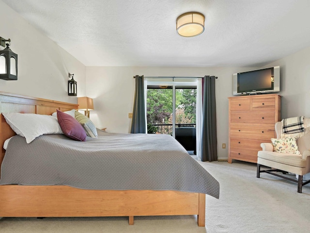 carpeted bedroom with access to exterior, a textured ceiling, and lofted ceiling