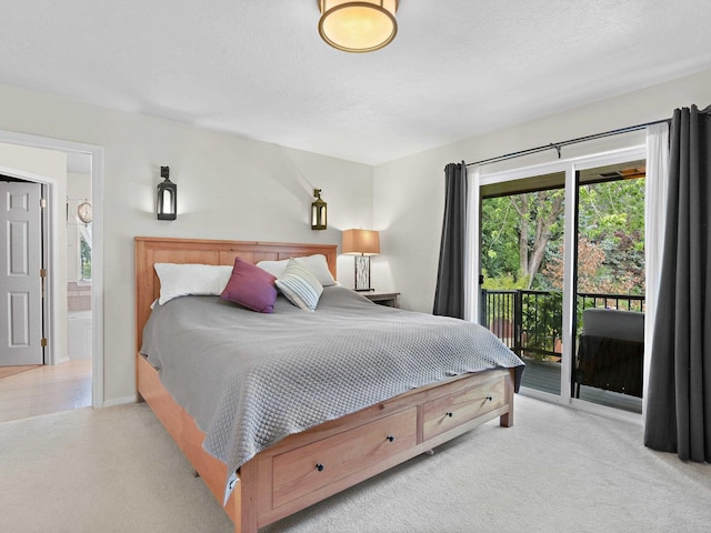 carpeted bedroom with access to exterior and ensuite bath