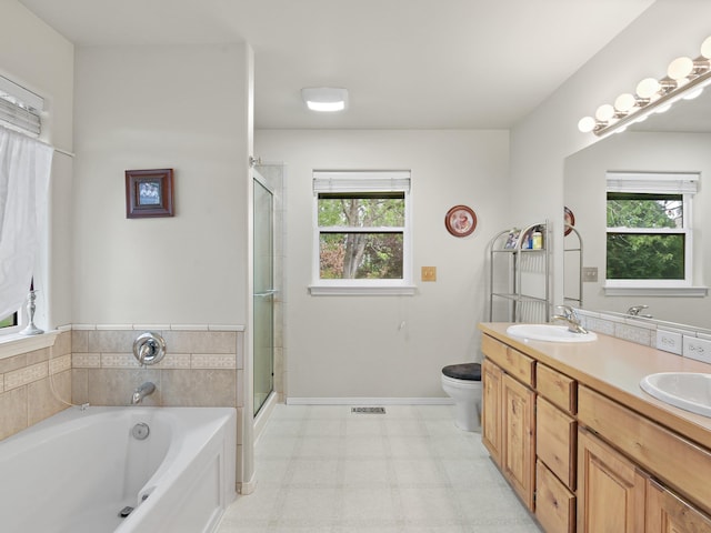 full bathroom featuring vanity, independent shower and bath, and toilet