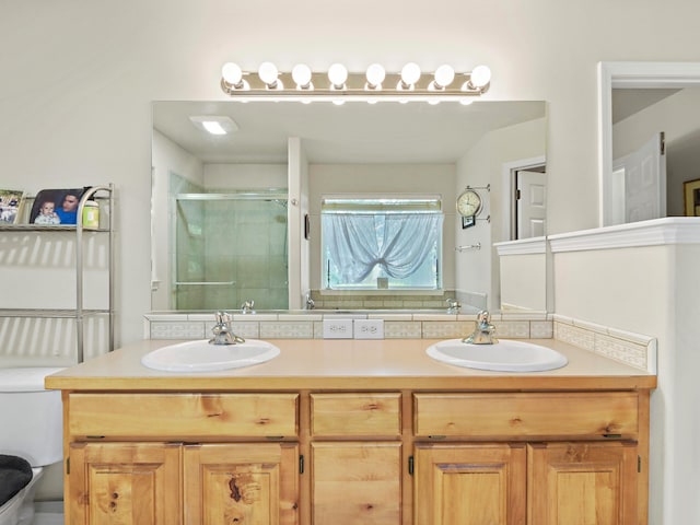 bathroom featuring vanity and a shower with door