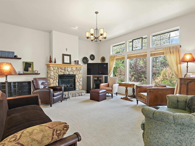 carpeted living room featuring a fireplace and a chandelier