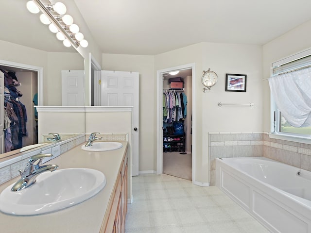 bathroom with vanity and a bath