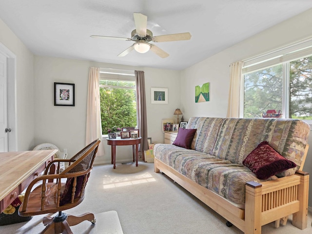 carpeted living room with ceiling fan