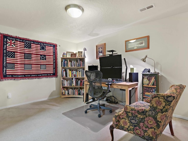 carpeted office featuring a textured ceiling