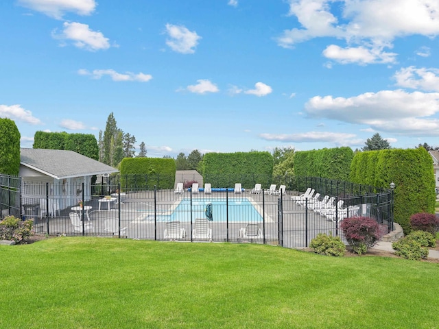 view of pool featuring a lawn and a patio area