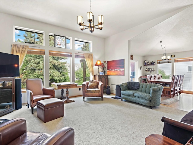 carpeted living room featuring a chandelier