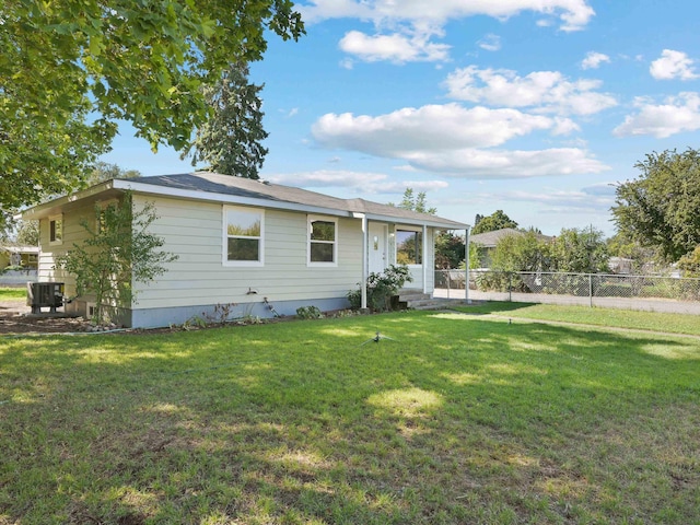 back of house featuring a lawn and central AC unit