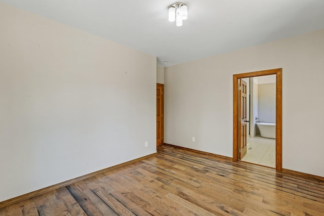 unfurnished room with light wood-type flooring