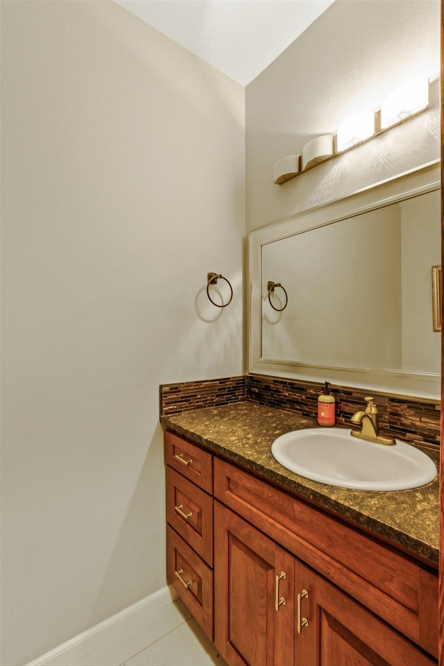 bathroom featuring backsplash, tile patterned flooring, and vanity