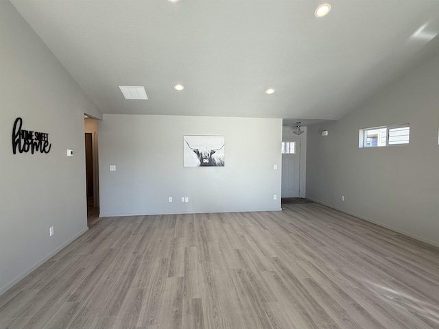 unfurnished living room featuring a ceiling fan, vaulted ceiling, recessed lighting, and light wood finished floors