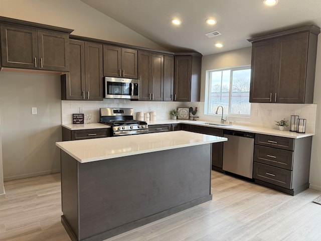 kitchen featuring a sink, visible vents, dark brown cabinetry, and appliances with stainless steel finishes