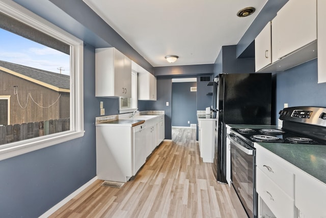 kitchen featuring white cabinets, sink, light wood-type flooring, and stainless steel range with electric cooktop