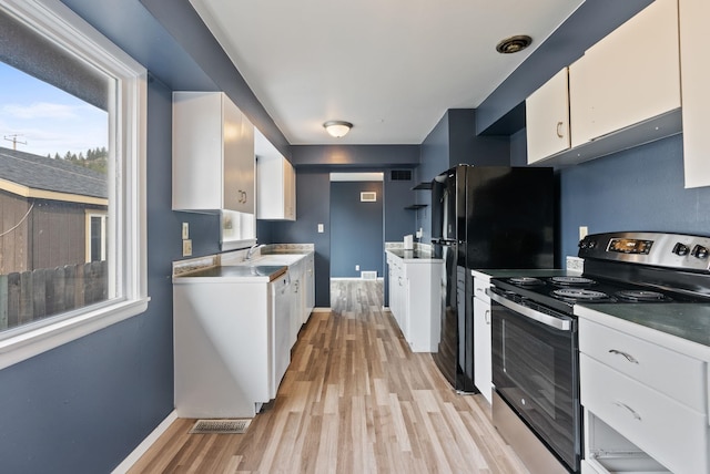 kitchen with white dishwasher, electric stove, sink, light wood-type flooring, and white cabinetry