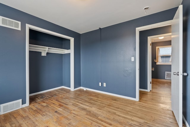 unfurnished bedroom featuring a closet and light hardwood / wood-style floors