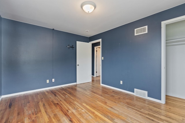 unfurnished bedroom featuring a closet and light hardwood / wood-style flooring