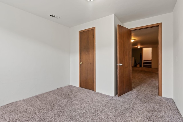 unfurnished bedroom with carpet floors and a closet