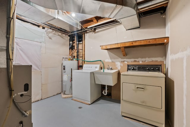 clothes washing area with electric water heater, washing machine and dryer, and sink