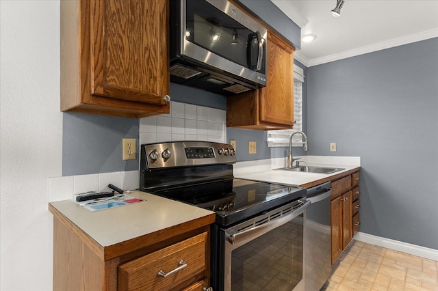 kitchen with backsplash, ornamental molding, sink, and appliances with stainless steel finishes