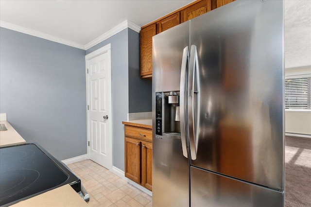 kitchen with stainless steel fridge, stove, and ornamental molding