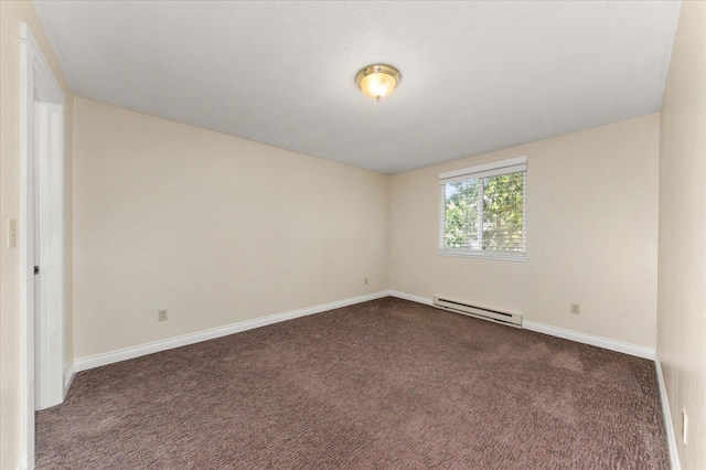 carpeted spare room featuring baseboard heating