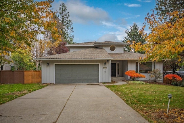 view of front of home with a garage and a front lawn