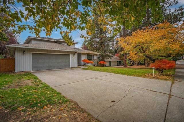 view of front of property with a front yard and a garage