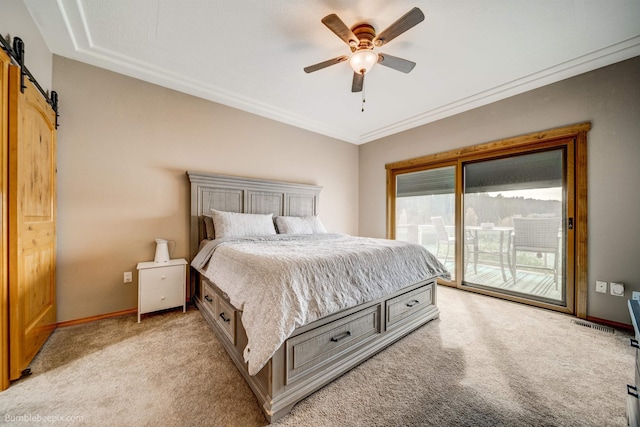 bedroom with access to exterior, light colored carpet, ceiling fan, crown molding, and a barn door