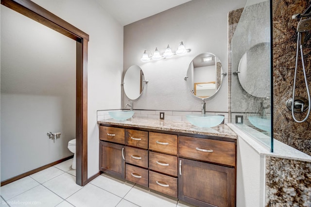 bathroom featuring tile patterned flooring, a shower, vanity, and toilet