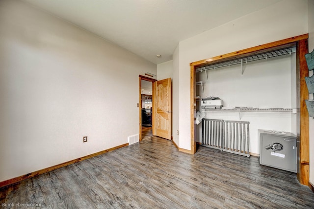 unfurnished bedroom featuring hardwood / wood-style flooring and a closet