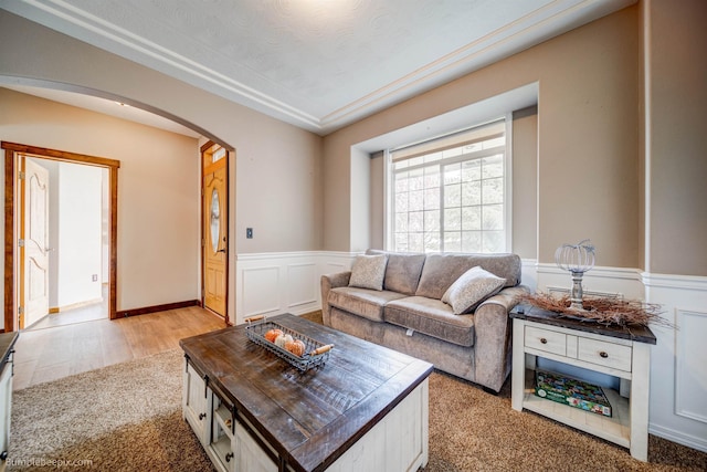 living room with a textured ceiling and light hardwood / wood-style flooring