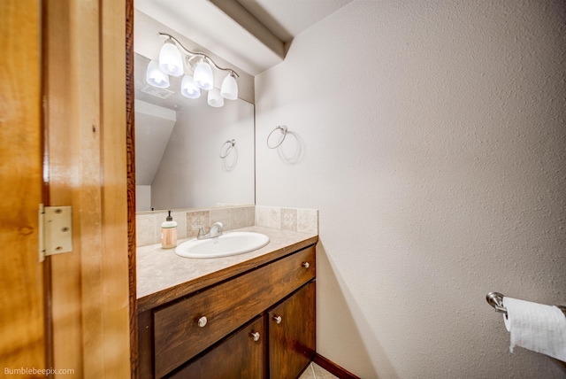 bathroom with vanity and lofted ceiling