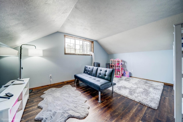 living area featuring dark hardwood / wood-style floors, a textured ceiling, and vaulted ceiling