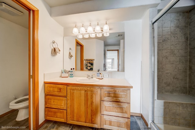 bathroom featuring hardwood / wood-style floors, vanity, toilet, and a shower with shower door