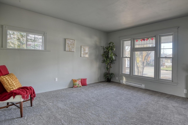 unfurnished room featuring carpet flooring, a baseboard radiator, and a healthy amount of sunlight