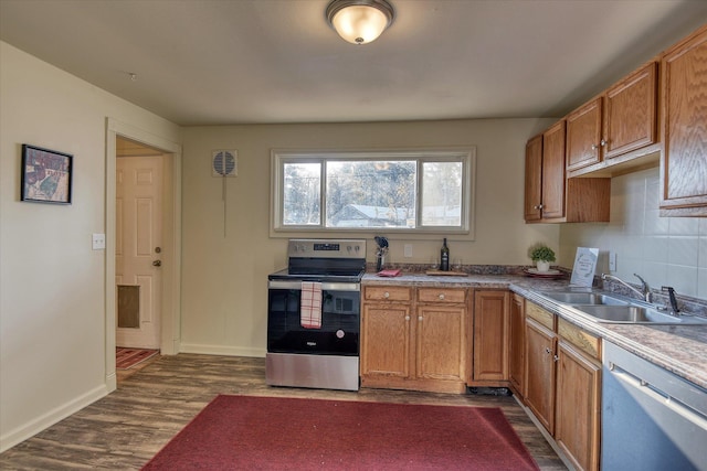 kitchen with backsplash, sink, stainless steel appliances, and dark wood-type flooring