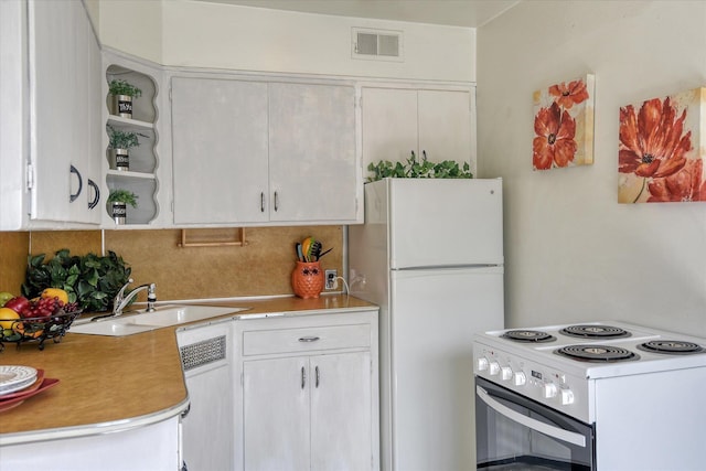 kitchen featuring decorative backsplash, white cabinetry, white appliances, and sink