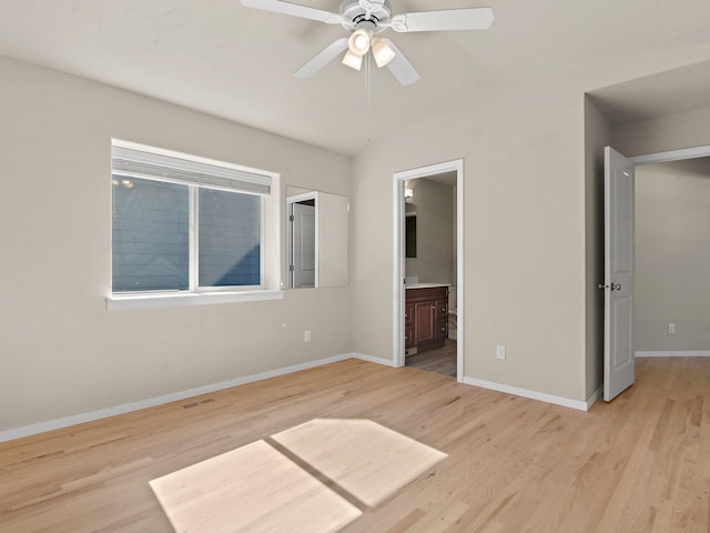 unfurnished bedroom with vaulted ceiling, ensuite bathroom, light hardwood / wood-style flooring, and ceiling fan