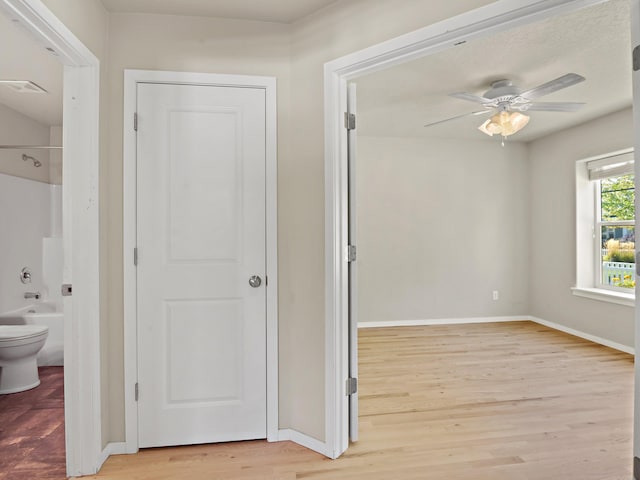 corridor with light wood-type flooring