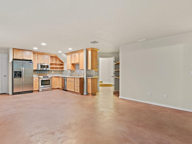 kitchen with appliances with stainless steel finishes, backsplash, light brown cabinetry, and sink