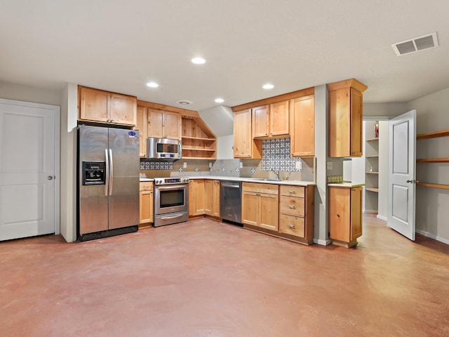 kitchen featuring decorative backsplash, appliances with stainless steel finishes, light brown cabinets, and sink