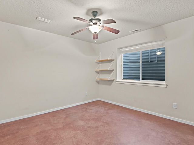 carpeted empty room with a textured ceiling and ceiling fan