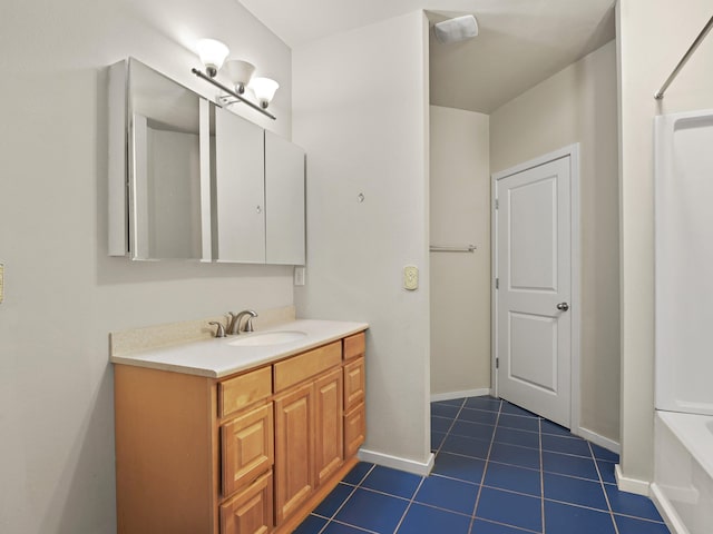 bathroom with tile patterned floors, vanity, and a bathtub