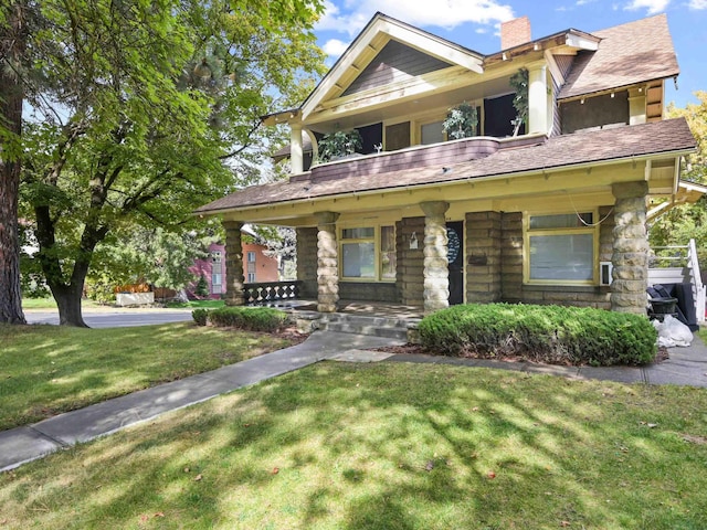 craftsman inspired home with a porch and a front lawn