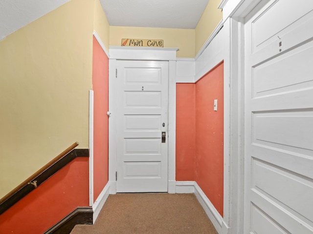 entryway with dark colored carpet