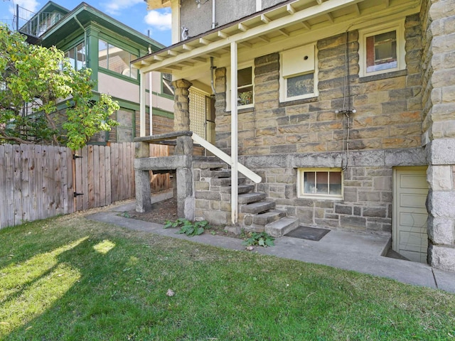 entrance to property featuring a yard