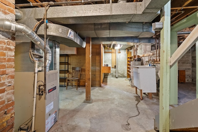 basement with water heater and brick wall